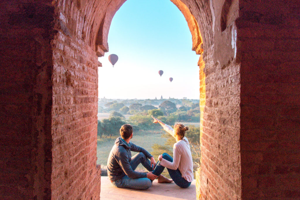 dos personas sentadas en el suelo y mirando el balón en Bagan, Myanmar